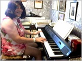 Click to hear Miss Denise play Bach's Fantasia in G Major - Denise is wearing  her flowery summer mini-dress